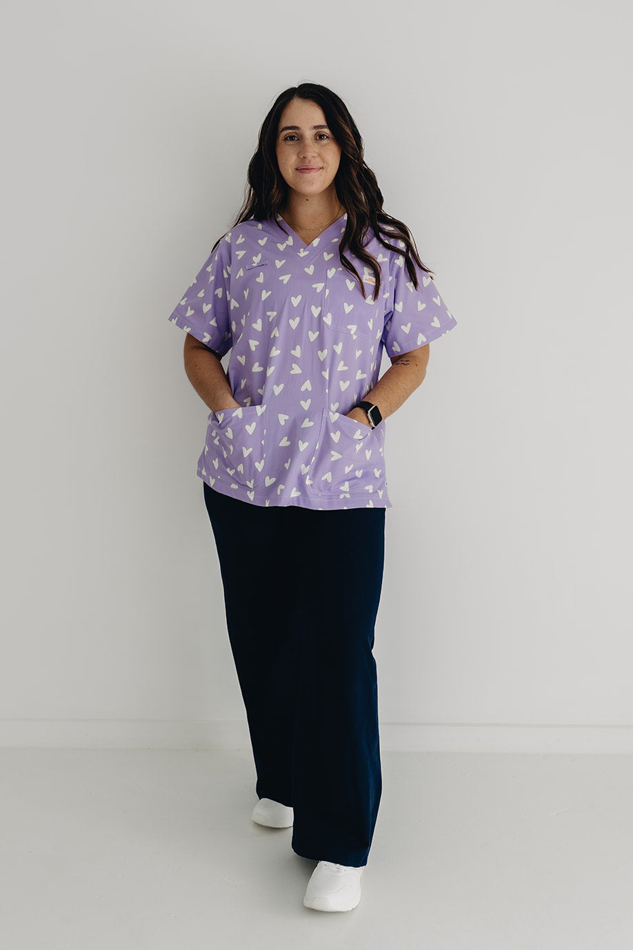 nurse wearing Chart My Heart printed scrub top by GET SCRUBBED
